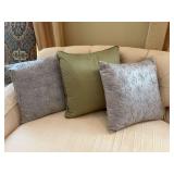 Set of three pillows, two silver, and one green