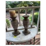 A pair of concrete 14 1/2 inch candle holders