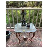 Glass top table with a 16” camel candle holder and 5 in.² ceramic pot. The table is 28“ x 24“ x 22“.