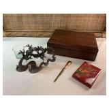 Grouping of home decor items including a 10 1/2 x 7 1/2“ wooden box an oriental themed folding mirror and letter opener and a bronze oriental look candle/orb holder.