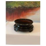 5 inch Fenton black glass three footed display stand. 1 foot does have damage to underneath as shown.