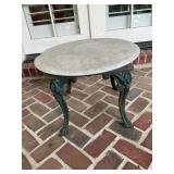 Round marble top table on cast-iron legs 23 inches round by 17 inches -the marble does have a chip on edge as shown