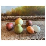 Four pieces of stone, mixed fruit, and  2 marble eggs