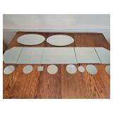 Mirrored table runner, two oval mirrored pieces, and smaller round and one square mirrored pieces. Table runner and two oval pieces are beveled glass.
