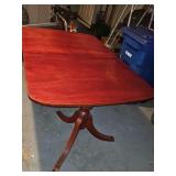 Duncan Phyfe dual pedestal table. 60.25 x 40 x 30 in tall. Includes one 12-in leaf.