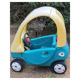 Classic weathered Little Tikes Cozy Coupe ride-on toy car.