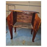 Mid-20th-century wooden telephone table or side table featuring integrated side pockets or magazine racks, constructed with solid cedar wood and distinctive scalloped side panels.