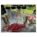 Containers of beaded garland, boxes of tree/decor lights.