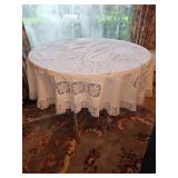 Round folding table. Includes table scarf. 40 in wide x 28 in tall.