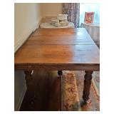 Antique tiger oak five leg dining table on casters. 43.5 x 62 hex 31 in tall including two 9 in. leaves inserted as shown.