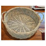Large wicker basket with handles. 24-in diameter x 7.5 in tall.