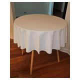 MDF four legged table with table scarf. 30 in diameter x 30 in tall.