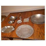Grouping of cast aluminum items. Top left two oval bowls are from Artland, center top is by Queens Art pewter cup dating to 1930s, Buenilum hand hammered leaf Tray, bottom right oval fruit tray is by 