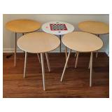 Five round MDF three-legged tables. One has a checker or chess board on top. 20-in diameter x 25.5 in tall.