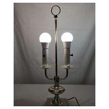 French two-arm brass bouillotte table lamp featuring a marble base. No shade. 20.5 in tall to top of finial.