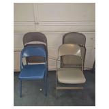 Six metal folding chairs. Four matching, two same style but different colors