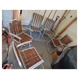 Three aluminum wood slat lawn chairs and two nylon covered lawn chairs.