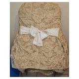 One folding chair and eight back tie chair covers.
