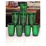 Set of 8 vintage Anchor Hocking forest green juice glasses in the pressed "Sandwich" pattern, featuring an embossed floral and stippled texture design produced during the mid-20th century.