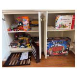 Contents of 2 bottom cabinets - games (some look new), puzzles, magic kit, magnetic tiles and more