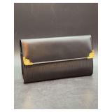 NIB - black leather Mikimoto travel jewelry roll featuring a suede interior lining, gold-tone hardware accents, and a snap closure