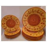 5 salad plates and six dinner plates, Pier 1 "Genoa" pattern, featuring a distinctive orange and rust leaf-and-berry border with a central rust-brown swirl.