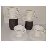 Four Indiana Glass Colony Harvest milk glass cups and saucers with an embossed grape and vine pattern.