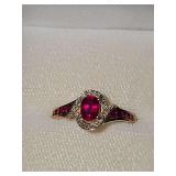 10K yellow gold ring with red and clear stones. Size 8 weighing 2.6 g.