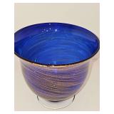 Beautiful hand-blown cobalt blue art glass pedestal bowl with a shimmering gold/copper swirl pattern and a clear glass footed base. 7x6.25 in tall.