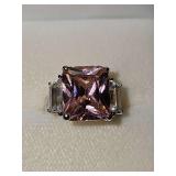 Sterling Silver ring with large pink stone and baguette stones on each side. Size 5 3/4.