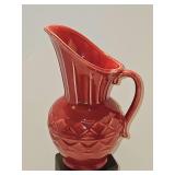 Shawnee Pottery 808 USA cranberry color pouring pitcher. 8 in tall. Pitcher is not chipped on bottom rim. Glaze was missed in the manufacturing process.