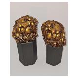 Resin cast lion heads in antique gold finish. Hole on bottom of each indicates they were probably used as a finial. Forex 4.75 x 4.25 in tall.