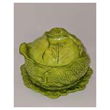 Holland mold green cabbage head bowl with lid and under plate. Exterior dimensions of Bowl are 7 in diameter x 6 in tall. Under plate is 8 in diameter