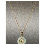 18K 15-in long chain with Jade and 14 karat gold charm. Chain weight 0.9 g, charm weight 1.4 g.