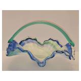 Murano or Ozark/Sooner glassmakers style hand-blown art glass centerpiece or candy bowl with a ruffled rim and a looped handle. 11.25 in diameter 8 in tall including handle.