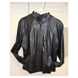 Black sheepskin leather slightly tailored ladies zip front jacket with two front pockets. Size large in very good condition.