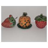 Jam or jelly servers sheped in strawberry, pineapple, and raspberry with lids. Two have spoons. 4-4.5 in tall.