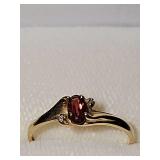 10K dainty yellow gold ring with red stone and clear chip stones. Size 6 weighing 1.2 g
