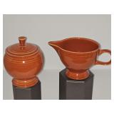 Fiestaware creamer and covered sugar bowl in persimmon glaze (?)