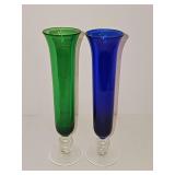 Cobalt blue and forest green bud vases featuring a flared rim and a clear footed pedestal base. 8 1/8 in tall