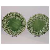 Two green Bordallo Pinheiro Majolica ceramic plates with an intricate, raised relief border of grapevine leaves and grape clusters. 9.25 in diameter.