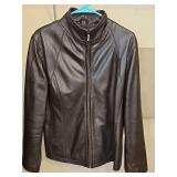 Nine West lambskin leather zip front jacket with seam pockets. Size large and good condition. Noticed a couple of spots that may come out with a leather treatment. See all photos.