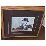Framed art print "Mid-Morning" (also known as "My Calf") by the late artist Nancy Noel (N.A. Noël), featuring an Amish boy resting next to a calf. 24.5 x 22.5 in tall.