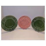 Two Bordallo Pinheiro 8 inch plates in the Papillon (Ivy Green) pattern from Portugal featuring a raised butterfly and wheat pattern. One 7.75 in pink grape plate by Bordallo Pinheiro. All have crazin