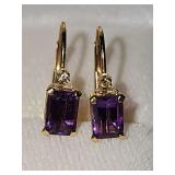 Pair of 14 karat yellow gold earrings with purple stones and tiny diamond chips. Weighing 1.0 g