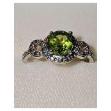Sterling Silver ring with peridot stone and accent diamond chips. Size 8.