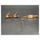 Selection of men’s apparel accessories - pair of wooden mallard duck cufflinks, gold tone tie tac with fishing fly encased in acrylic, and a tie tac with a fly rod