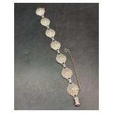 Sterling brace with floral medallion and rhinestone accents - butterfly clasp is marked Sterling - 27 grams - missing 1 stone