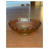 Fenton Marigold Stippled Rays carnival glass bowl, featuring an iridescent orange marigold finish and ribbed exterior - 5-1/2”D x 2” tall