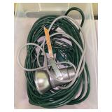 Clear plastic storage box with extension cords and spotlight
